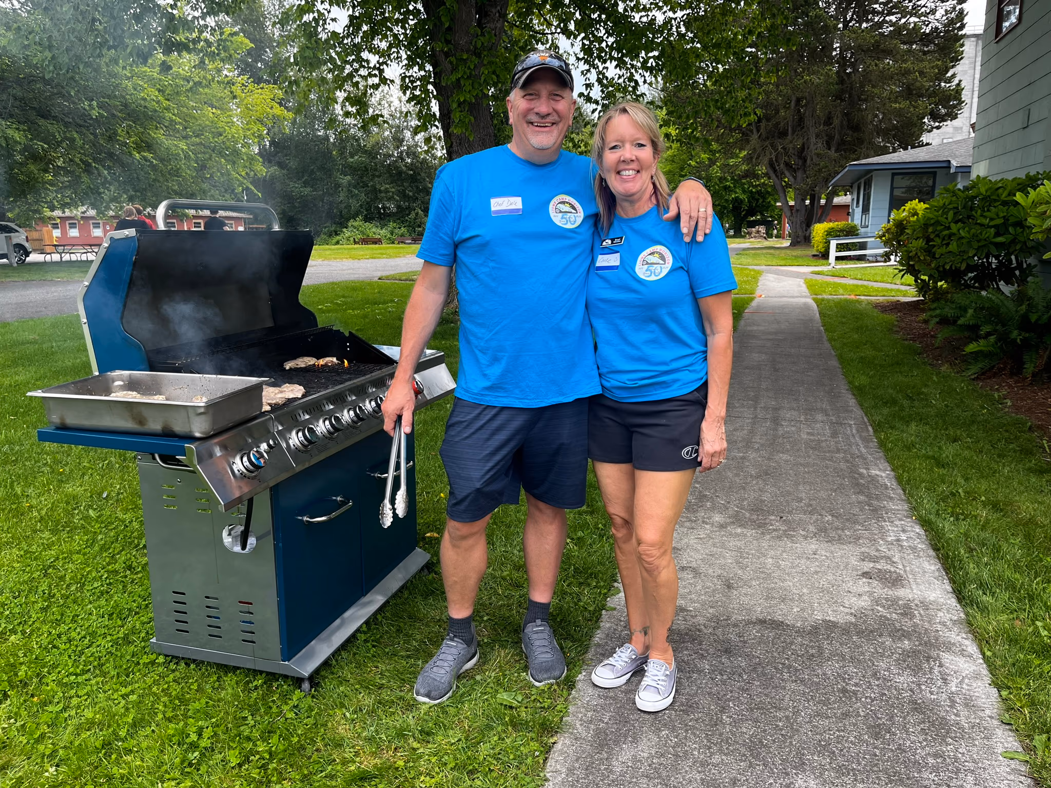 A couple in front of a barbecue