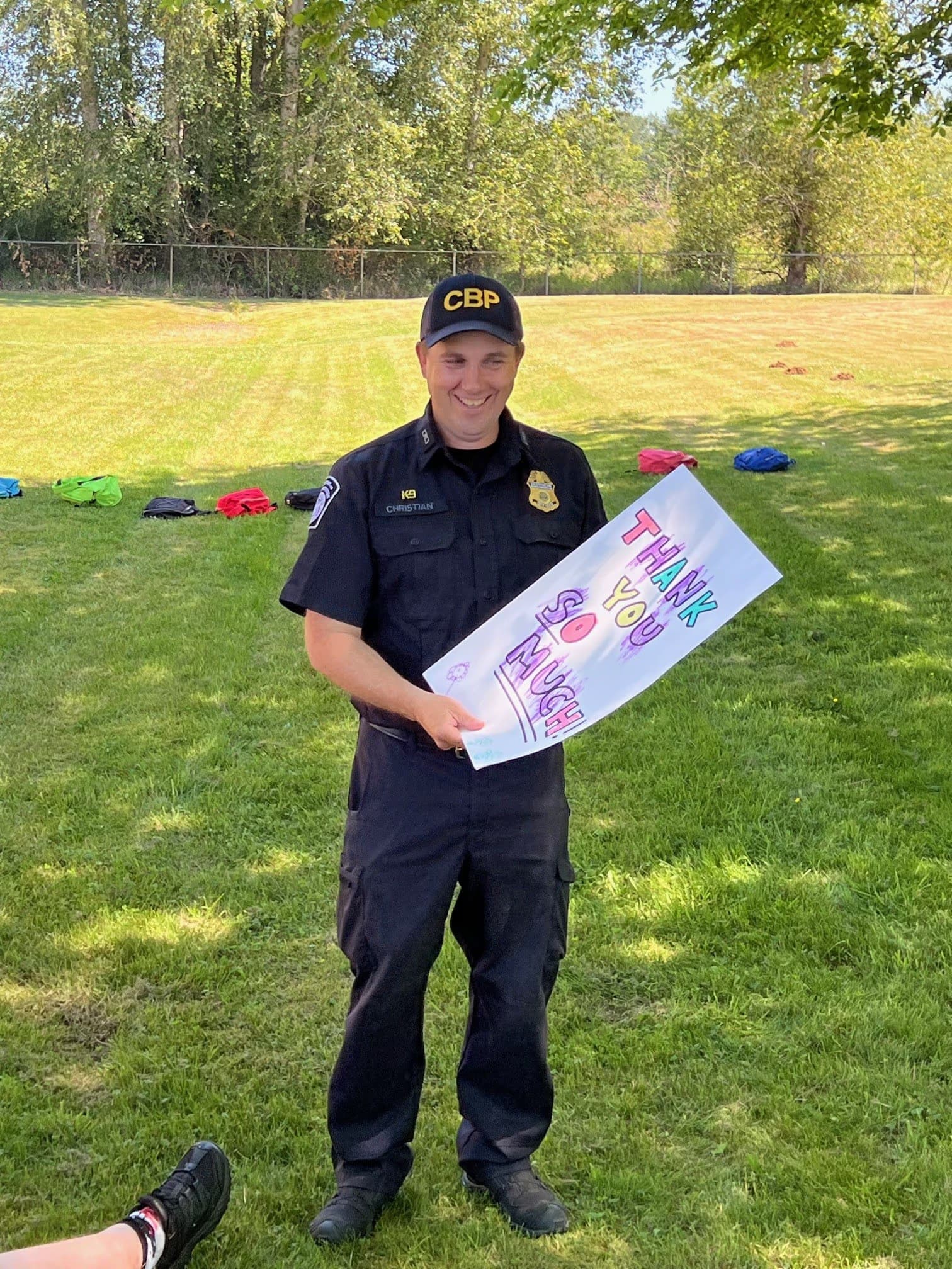 a border patrol agent with a thank you card