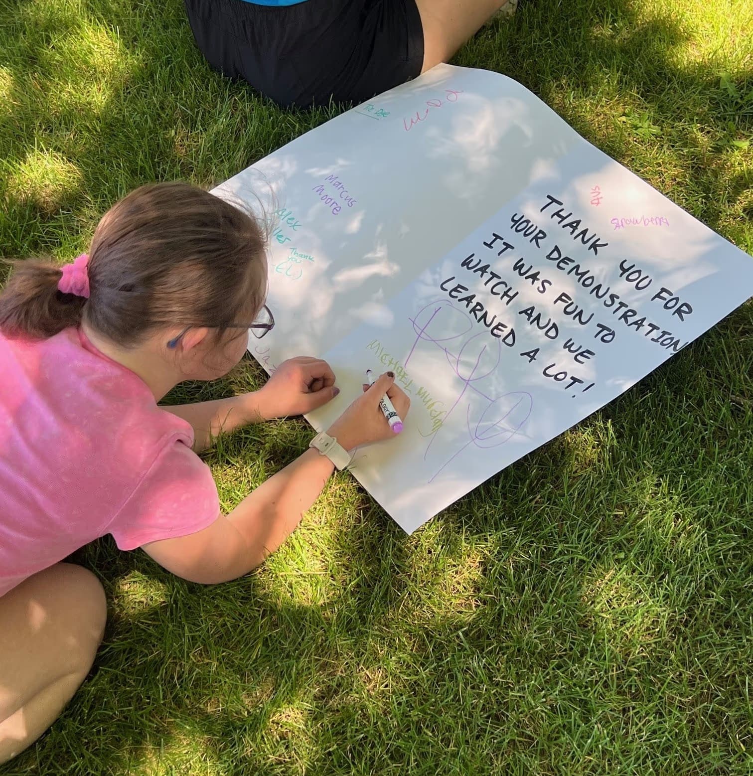 a camper writing a thank you card