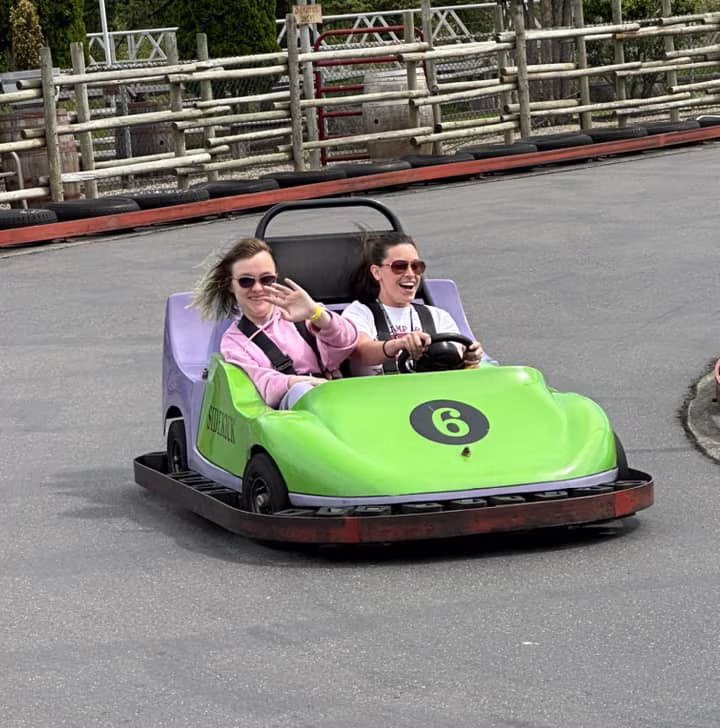 camper and counselor in a go kart