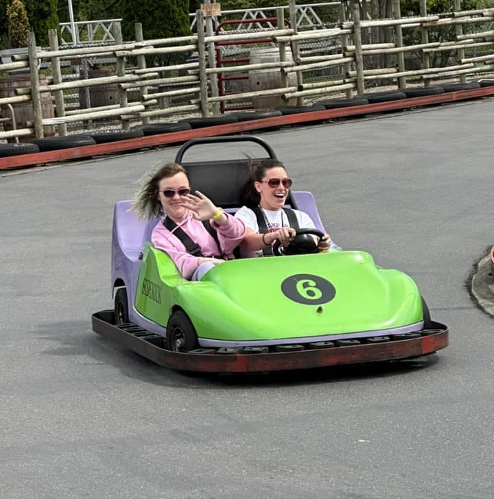 camper and counselor in a go kart
