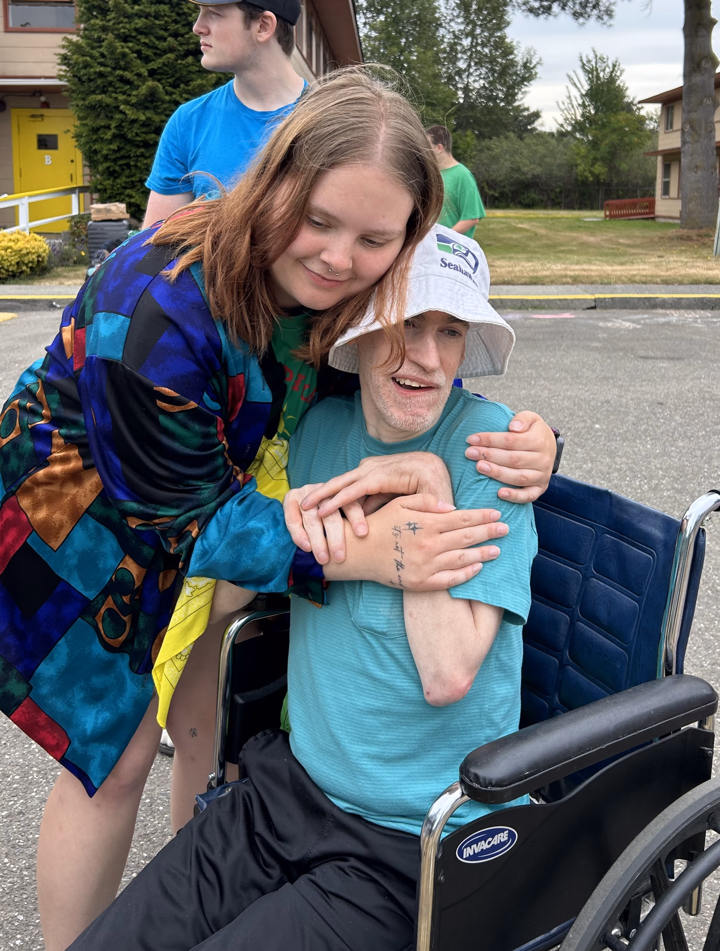 a camper and counselor hugging